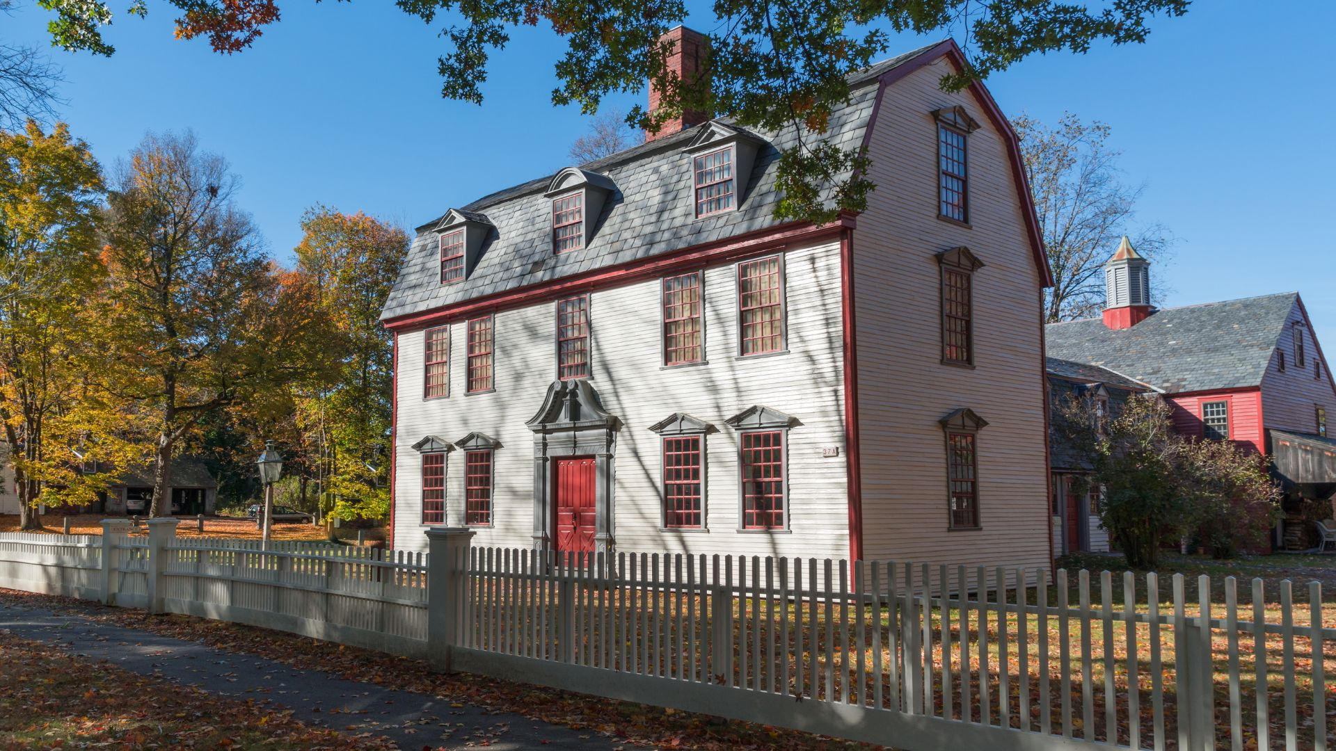 Eco-friendly painting setup in front of a historic home, emphasizing preservation methods